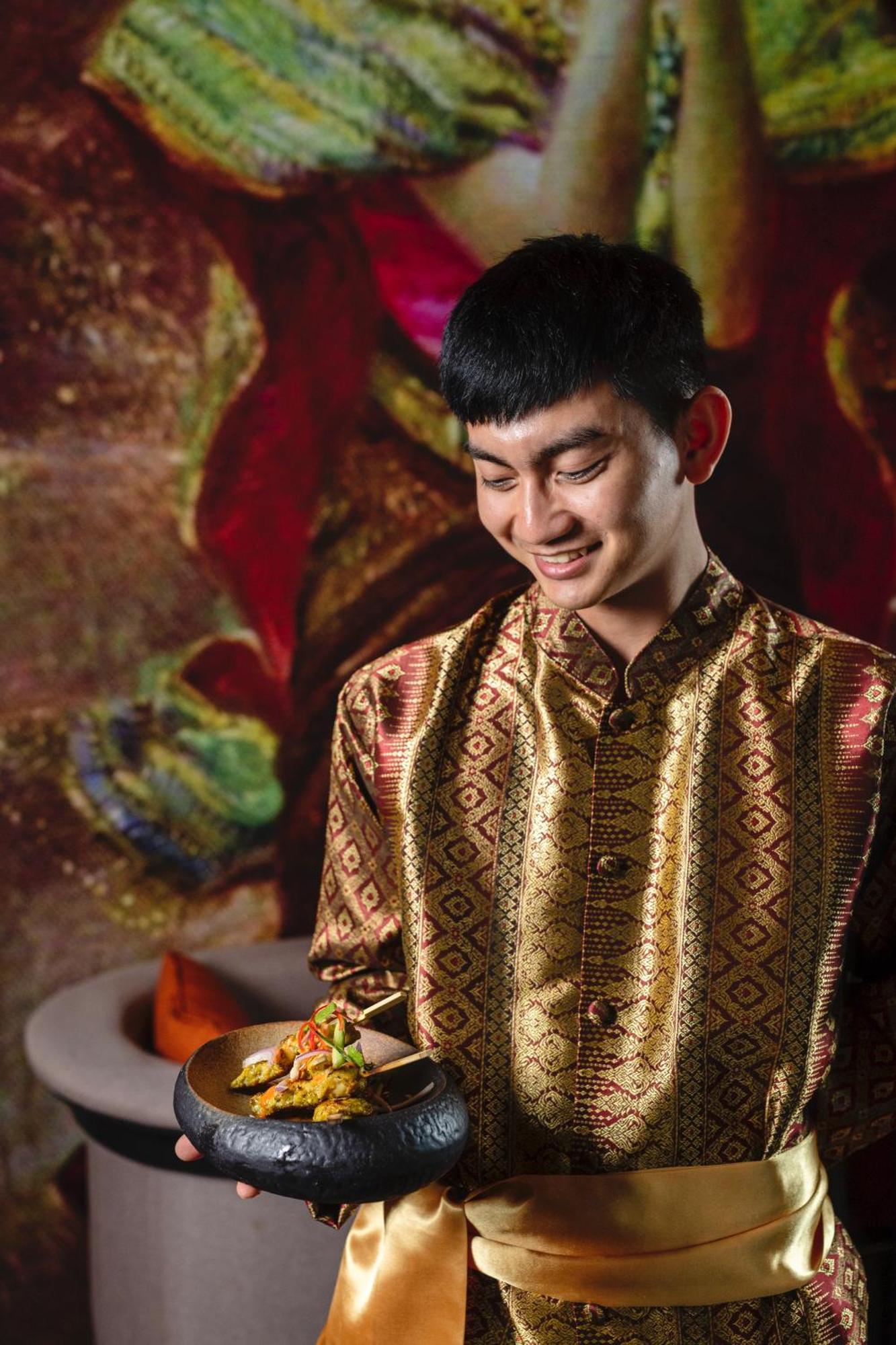 Dusit Doha Hotel Exterior photo A Thai man wearing a Thai shirt